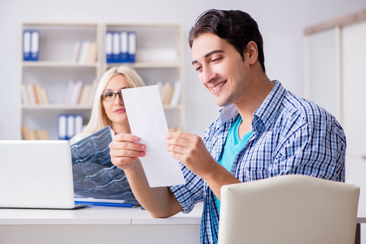 Male Patient Looking at Bill