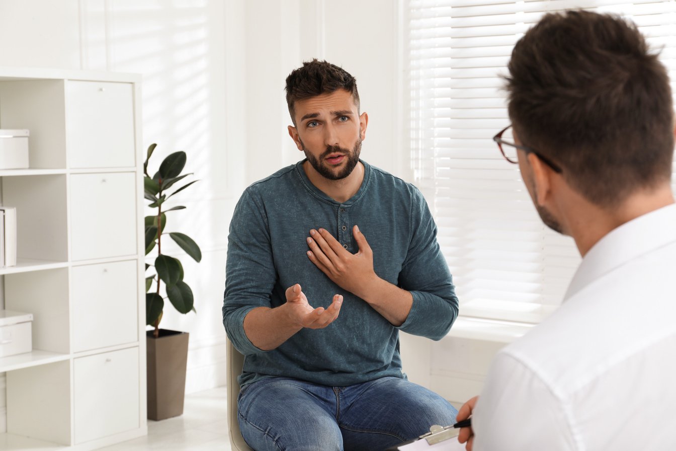 Psychotherapist Working with Drug Addicted Man Indoors